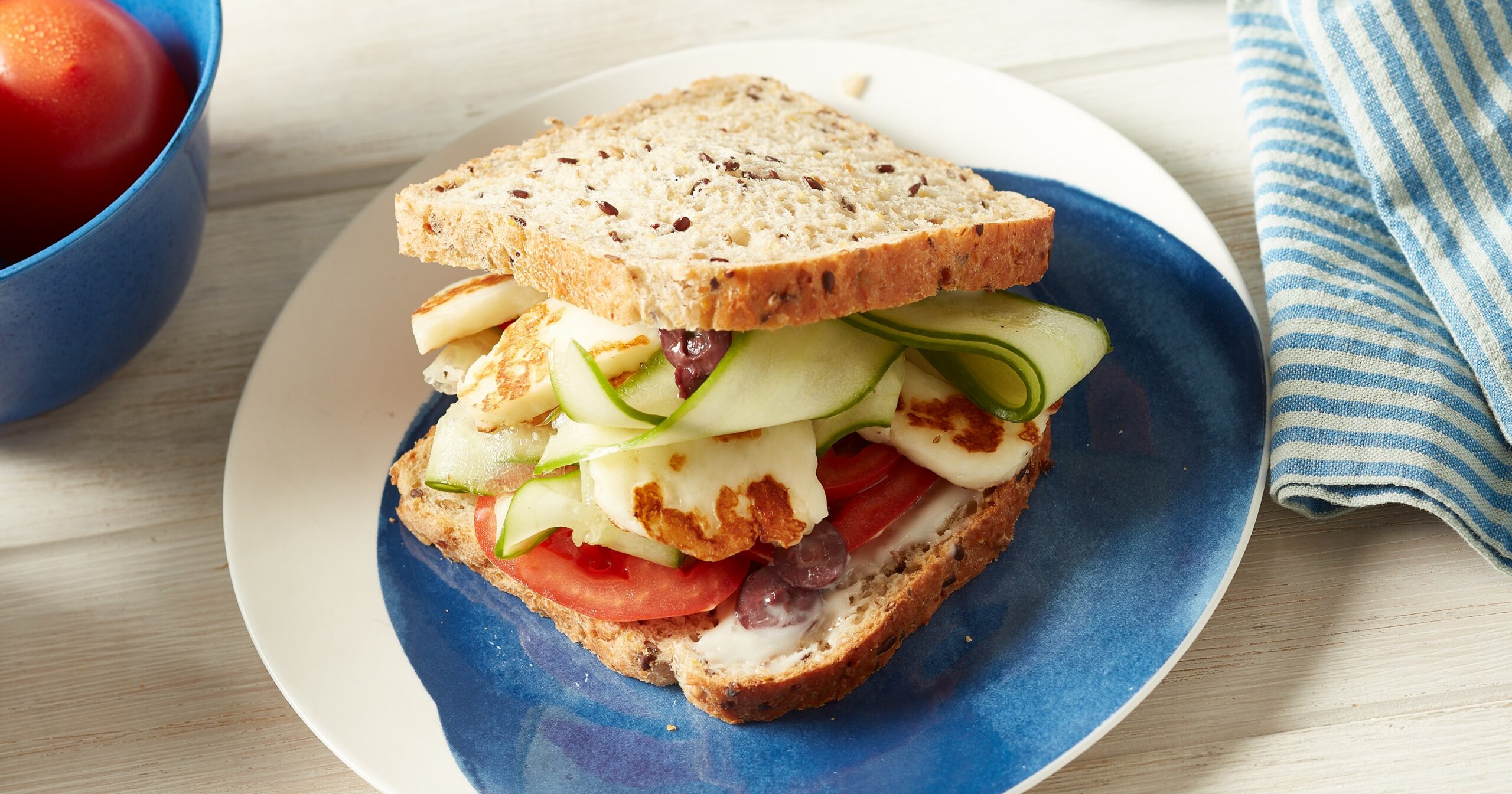 Haloumi, green olive tapenade and sliced tomato sandwich